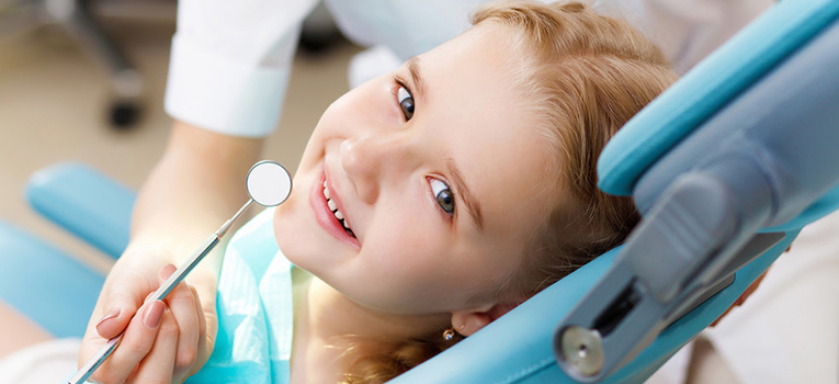 A kid receives dental sealant treatment